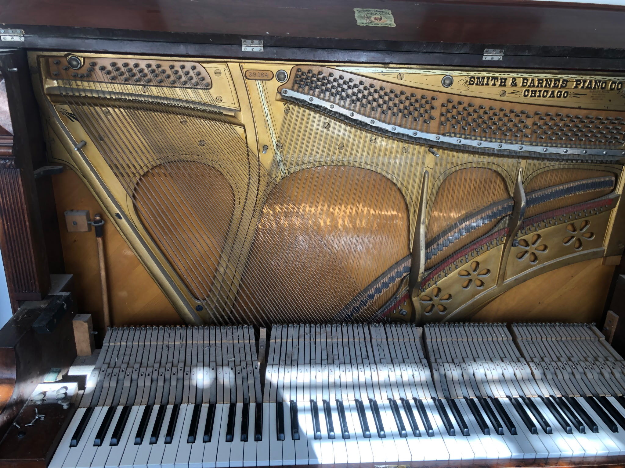 A partially disassembled upright piano